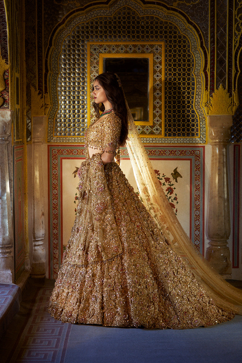 This gold lehenga set features an exaggerated flare at the back, showcasing  a free-flowing trail.... | Lehenga, Golden bridal lehenga, Indian bridal  dress